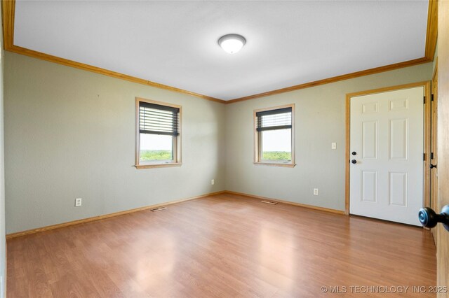 4418 N Little, Cushing, OK 74023 - spare room featuring crown molding, plenty of natural light, and wood finished floors