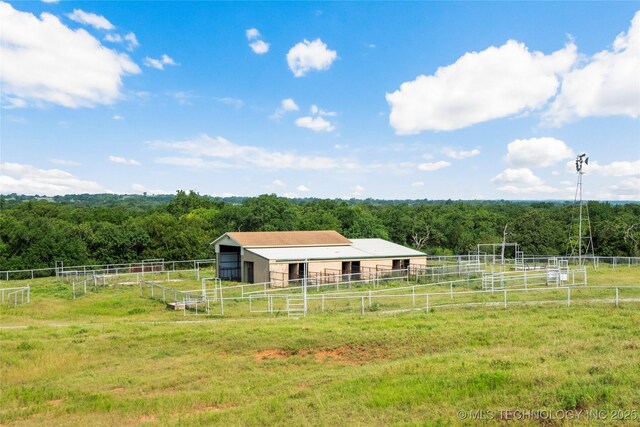 4418 N Little, Cushing, OK 74023 - view of yard featuring an exterior structure, a wooded view, a view of countryside, and an outdoor structure