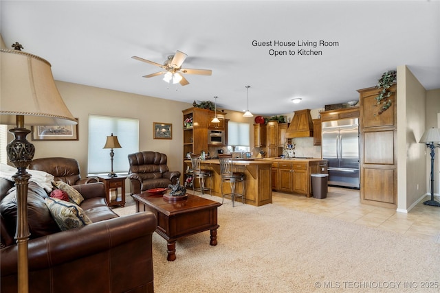 4418 N Little, Cushing, OK 74023 - living area featuring a ceiling fan, healthy amount of natural light, light tile patterned floors, and light carpet