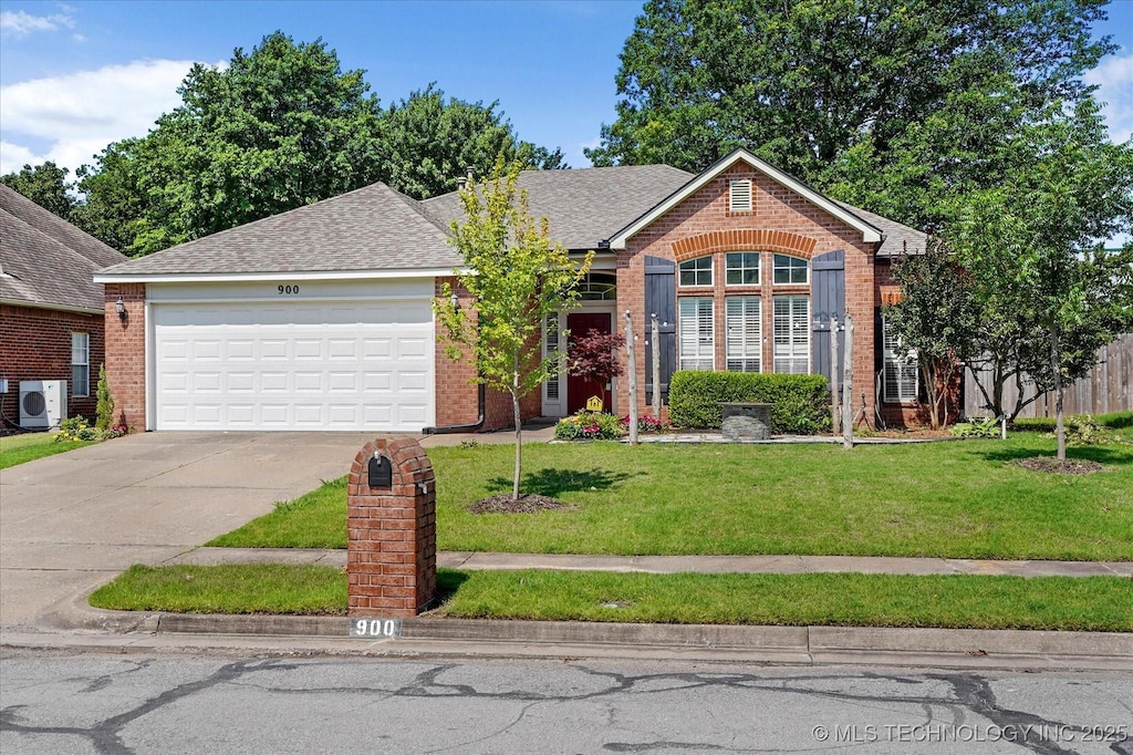 900 N Hemlock Ave, Broken Arrow, OK 74012 - view of front of home featuring ac unit, brick siding, concrete driveway, an attached garage, and a front yard