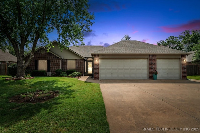9921 N 119th E Ave, Owasso, OK 74055 - ranch-style house featuring a garage, concrete driveway, brick siding, and a front lawn