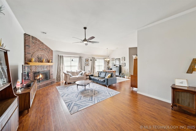 9921 N 119th E Ave, Owasso, OK 74055 - living area with a ceiling fan, a brick fireplace, wood finished floors, and baseboards
