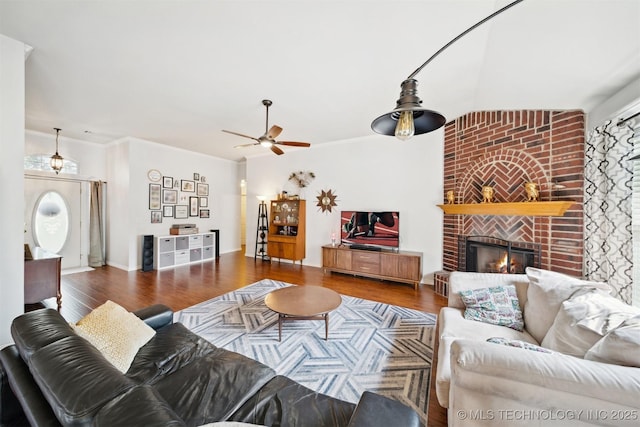 9921 N 119th E Ave, Owasso, OK 74055 - living room with wood finished floors, ceiling fan, and a brick fireplace