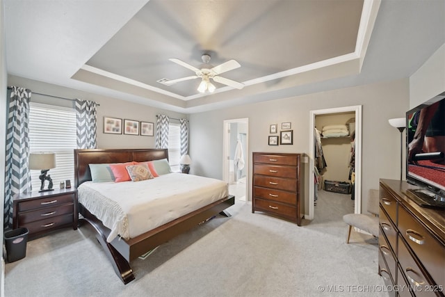 9921 N 119th E Ave, Owasso, OK 74055 - bedroom featuring a tray ceiling, light colored carpet, a spacious closet, ceiling fan, and ensuite bath