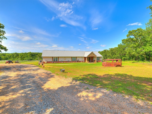 830294 S 3530, Stroud, OK 74079 - view of front facade featuring metal roof, driveway, and a front lawn