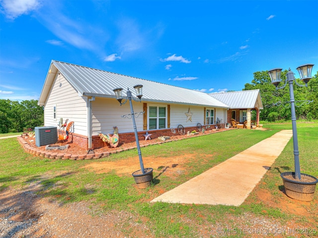830294 S 3530, Stroud, OK 74079 - rear view of property featuring cooling unit, a lawn, and metal roof