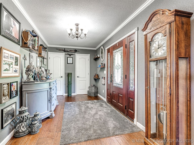 830294 S 3530, Stroud, OK 74079 - foyer featuring a chandelier, a textured ceiling, hardwood / wood-style floors, crown molding, and baseboards