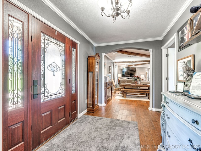 830294 S 3530, Stroud, OK 74079 - entrance foyer with arched walkways, dark wood-type flooring, a textured ceiling, baseboards, and ornamental molding