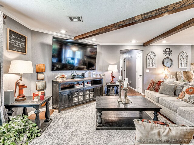 830294 S 3530, Stroud, OK 74079 - living room featuring arched walkways, ornamental molding, beamed ceiling, wood finished floors, and recessed lighting