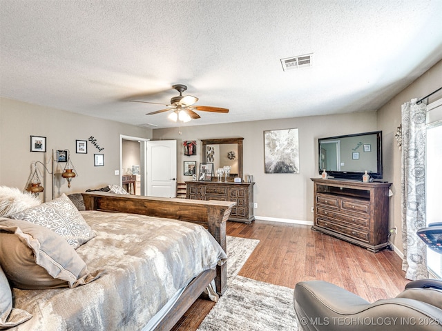 830294 S 3530, Stroud, OK 74079 - bedroom with wood finished floors, baseboards, a textured ceiling, and ceiling fan