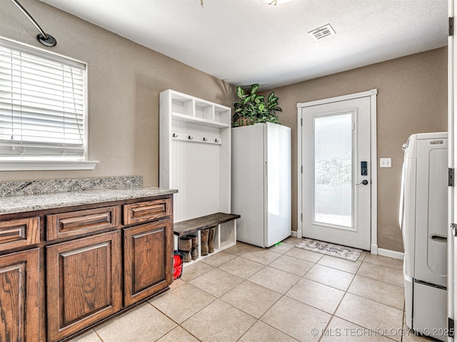 830294 S 3530, Stroud, OK 74079 - mudroom with light tile patterned floors, washer / dryer, and a textured wall