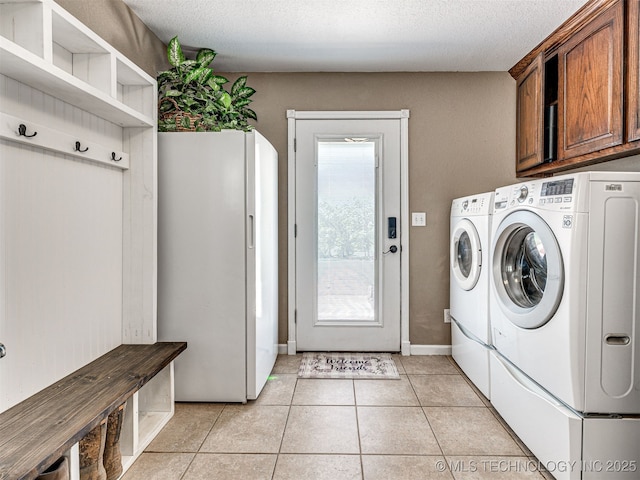 830294 S 3530, Stroud, OK 74079 - washroom with washer and clothes dryer, cabinet space, light tile patterned floors, and a textured ceiling