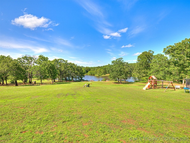 830294 S 3530, Stroud, OK 74079 - view of green lawn with a water view, a trampoline, and view of scattered trees