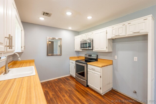 1605 W Montgomery St, Broken Arrow, OK 74012 - kitchen featuring stainless steel appliances, wooden counters, a sink, white cabinets, and recessed lighting