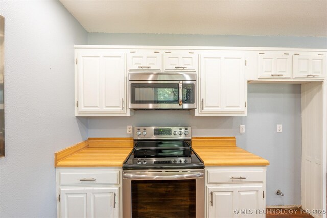 1605 W Montgomery St, Broken Arrow, OK 74012 - kitchen with stainless steel appliances, white cabinets, and butcher block countertops
