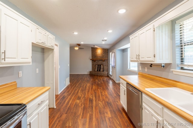 1605 W Montgomery St, Broken Arrow, OK 74012 - kitchen featuring dishwasher, a brick fireplace, white cabinets, plenty of natural light, and recessed lighting