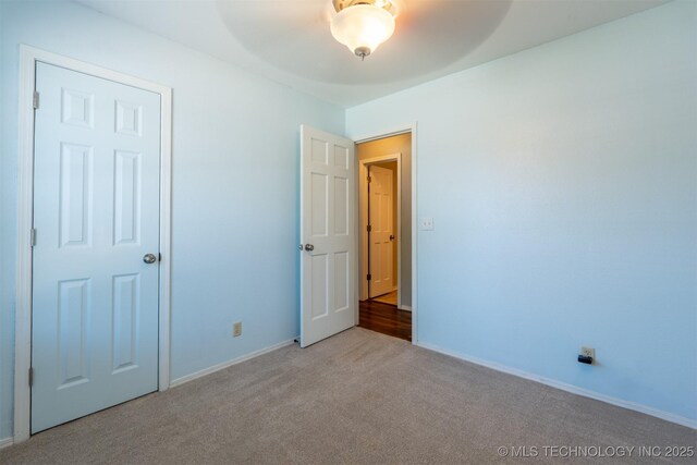 1605 W Montgomery St, Broken Arrow, OK 74012 - unfurnished bedroom featuring carpet floors, baseboards, and a ceiling fan