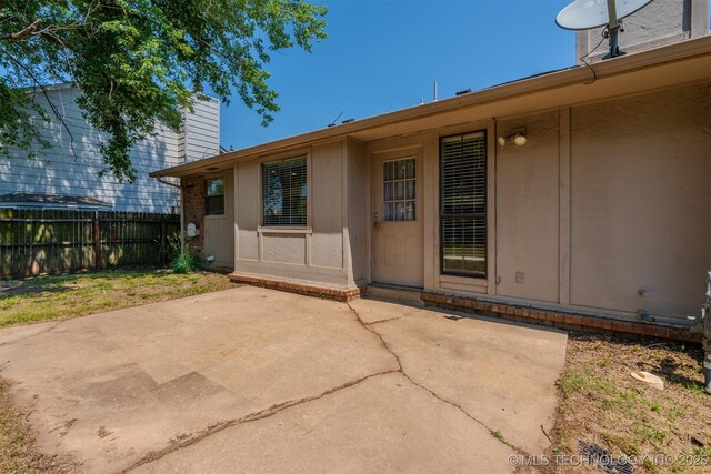 1605 W Montgomery St, Broken Arrow, OK 74012 - doorway to property with a patio area and a chimney