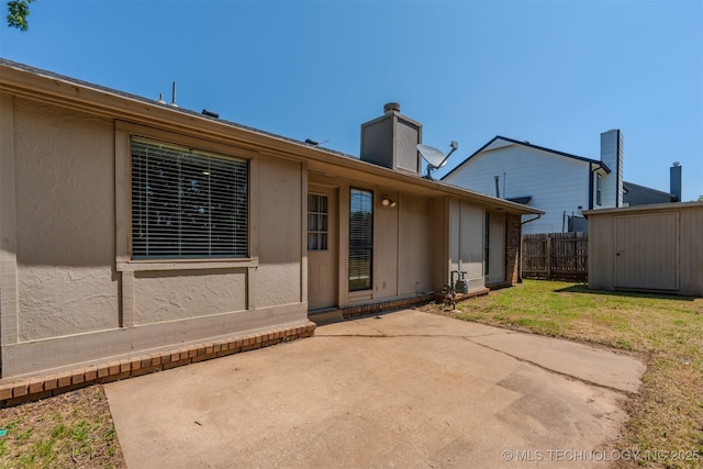 1605 W Montgomery St, Broken Arrow, OK 74012 - back of property featuring a patio and a chimney