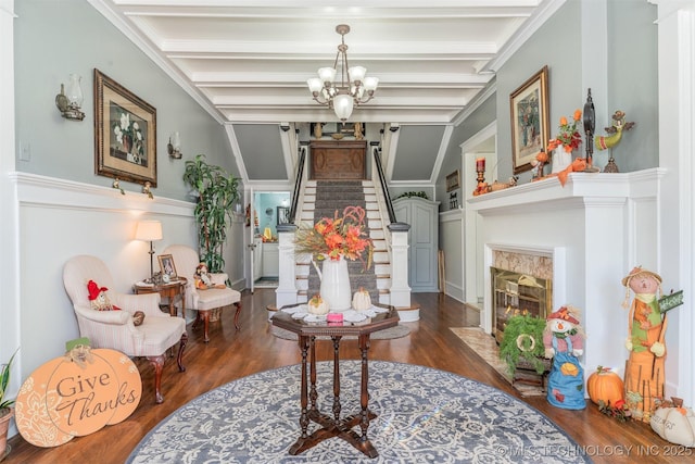 211 F SW, Ardmore, OK 73401 - foyer entrance featuring wood finished floors, a chandelier, beam ceiling, stairs, and a high end fireplace