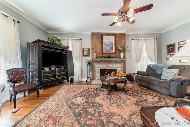 211 F SW, Ardmore, OK 73401 - living room with ceiling fan, ornamental molding, wood finished floors, and a stone fireplace