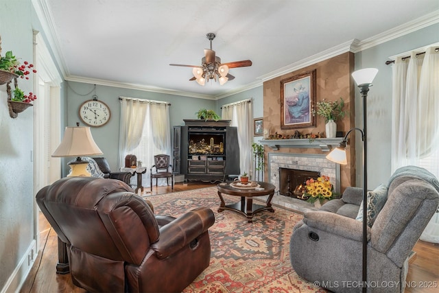 211 F SW, Ardmore, OK 73401 - living area with crown molding, ceiling fan, wood finished floors, and a fireplace