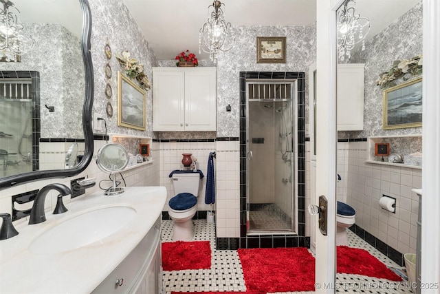 211 F SW, Ardmore, OK 73401 - bathroom featuring tile walls, toilet, vanity, tile patterned floors, and a stall shower