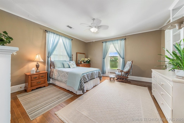 211 F SW, Ardmore, OK 73401 - bedroom featuring wood finished floors, crown molding, baseboards, and ceiling fan
