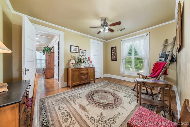 211 F SW, Ardmore, OK 73401 - living area with plenty of natural light, light wood-style floors, baseboards, and ornamental molding