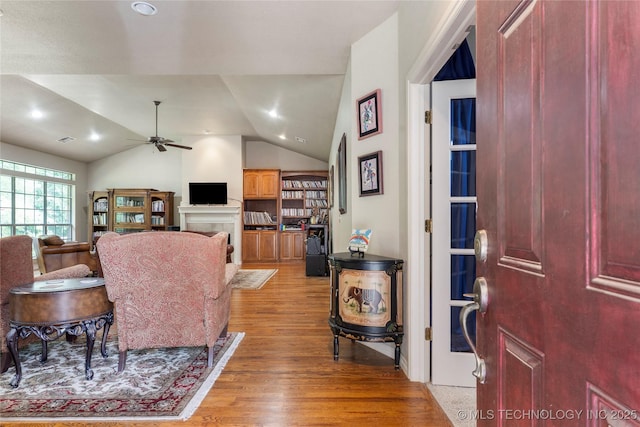 420 Fox Wood Dr, Sapulpa, OK 74066 - living room featuring light wood-type flooring, ceiling fan, lofted ceiling, a tiled fireplace, and recessed lighting