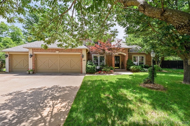 11586 S 66th E Ave, Bixby, OK 74008 - view of front of home with an attached garage, concrete driveway, a front lawn, brick siding, and roof with shingles