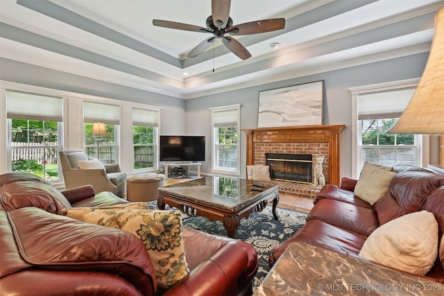 11586 S 66th E Ave, Bixby, OK 74008 - living room with crown molding, a ceiling fan, healthy amount of natural light, a brick fireplace, and a tray ceiling