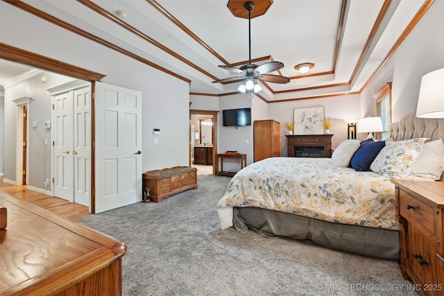11586 S 66th E Ave, Bixby, OK 74008 - bedroom with crown molding, a tray ceiling, carpet floors, a fireplace, and ensuite bathroom