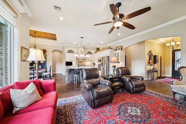 13234 S 68th E Ave, Bixby, OK 74008 - living room featuring arched walkways, dark wood-style flooring, crown molding, ceiling fan, and baseboards