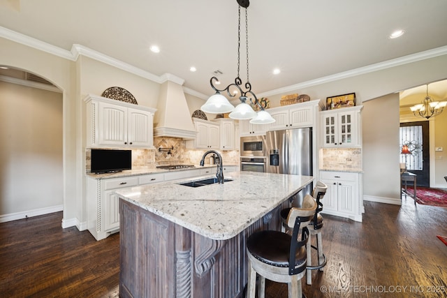 13234 S 68th E Ave, Bixby, OK 74008 - kitchen featuring appliances with stainless steel finishes, a sink, custom range hood, a center island with sink, and decorative backsplash
