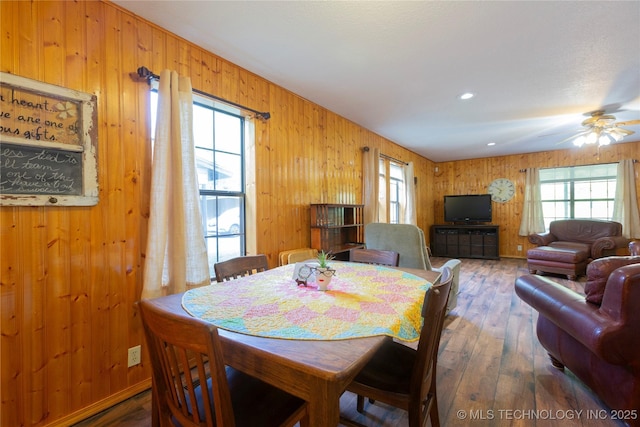 162 Dolittle Ln, Mcalester, OK 74501 - dining area featuring hardwood / wood-style flooring, wooden walls, and ceiling fan