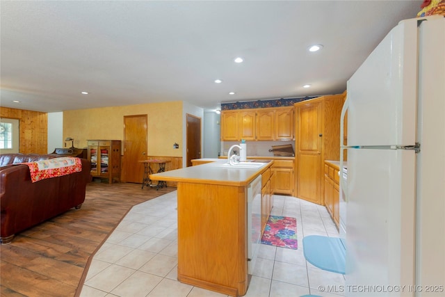 162 Dolittle Ln, Mcalester, OK 74501 - kitchen featuring freestanding refrigerator, open floor plan, an island with sink, light countertops, and light tile patterned floors