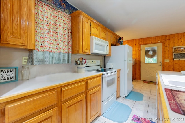 162 Dolittle Ln, Mcalester, OK 74501 - kitchen with white appliances, light countertops, light tile patterned floors, wooden walls, and a sink