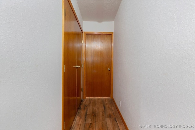 162 Dolittle Ln, Mcalester, OK 74501 - corridor featuring wood finished floors, a textured wall, and a textured ceiling