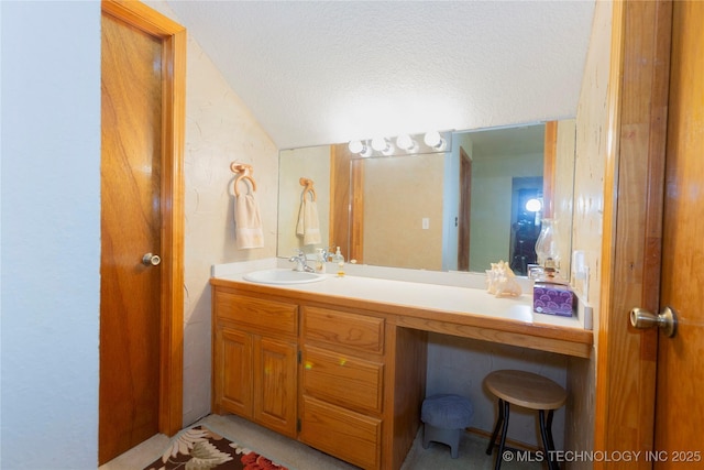 162 Dolittle Ln, Mcalester, OK 74501 - bathroom featuring a textured ceiling, vanity, and lofted ceiling