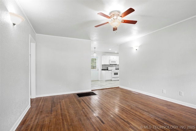 7128 E 5th Pl, Tulsa, OK 74112 - unfurnished living room with a ceiling fan, wood-type flooring, crown molding, and baseboards