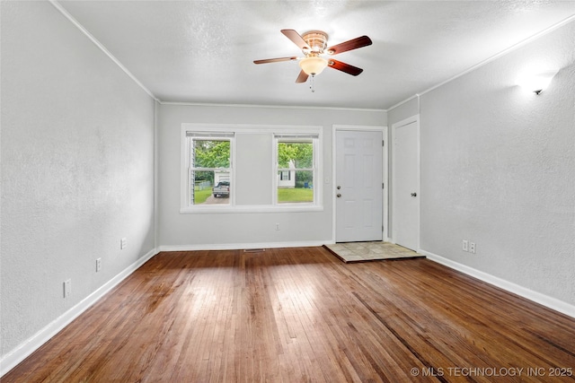 7128 E 5th Pl, Tulsa, OK 74112 - empty room featuring ceiling fan, wood finished floors, a textured wall, baseboards, and ornamental molding