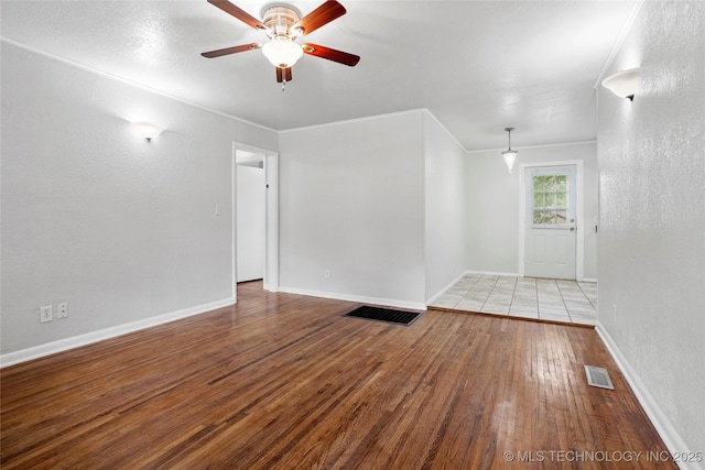7128 E 5th Pl, Tulsa, OK 74112 - unfurnished room featuring hardwood / wood-style flooring, ornamental molding, ceiling fan, and baseboards