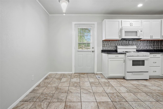 7128 E 5th Pl, Tulsa, OK 74112 - kitchen featuring white appliances, dark countertops, ornamental molding, white cabinetry, and decorative backsplash