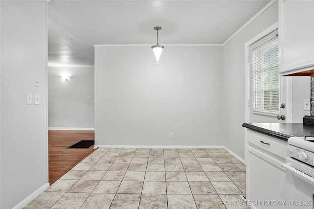 7128 E 5th Pl, Tulsa, OK 74112 - unfurnished dining area with crown molding and baseboards