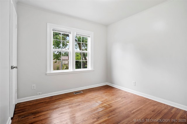 7128 E 5th Pl, Tulsa, OK 74112 - unfurnished room with ornamental molding, wood finished floors, and baseboards