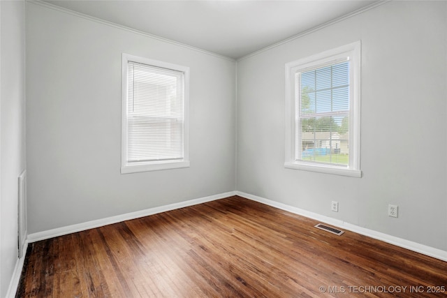 7128 E 5th Pl, Tulsa, OK 74112 - empty room featuring baseboards, crown molding, and wood finished floors