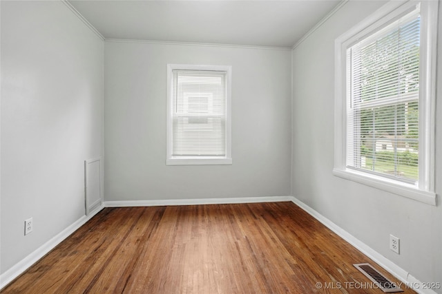 7128 E 5th Pl, Tulsa, OK 74112 - spare room featuring crown molding, wood finished floors, and baseboards