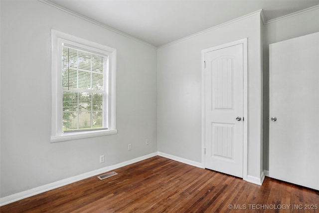 7128 E 5th Pl, Tulsa, OK 74112 - unfurnished room featuring plenty of natural light, crown molding, dark wood-style floors, and baseboards