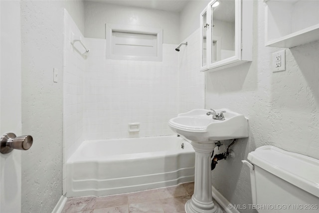7128 E 5th Pl, Tulsa, OK 74112 - full bath with a textured wall, bathing tub / shower combination, and toilet